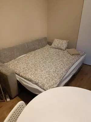 a bed in a room with a couch at AppartCosy in Liège