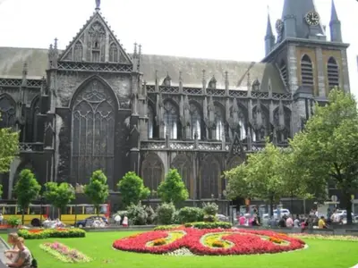 a large cathedral with a flower clock in front of it at AppartCosy in Liège