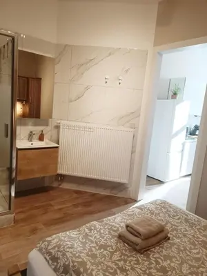 a bathroom with a bed and a sink at AppartCosy in Liège