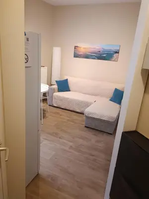 a living room with a couch and a table at AppartCosy in Liège