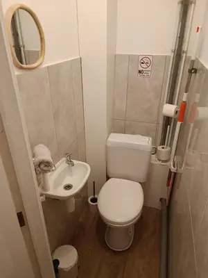 a small bathroom with a toilet and a sink at AppartCosy in Liège