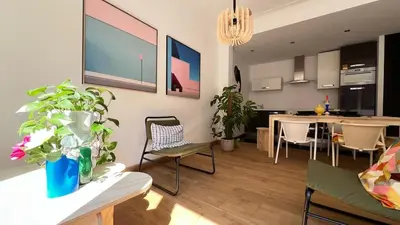 a living room with a kitchen and a dining room at Cozy Neuvice apartment in Liège