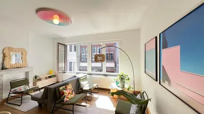 a living room with a couch and chairs and windows at 202 Le Coeur de Liege in Liège