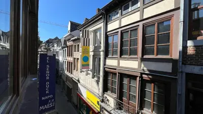 a building with a sign on the side of a street at 202 Le Coeur de Liege in Liège