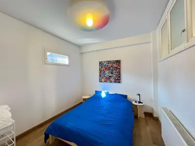 a bedroom with a blue bed in a room at 202 Le Coeur de Liege in Liège