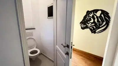 a bathroom with a lion head decal on the wall at 202 Le Coeur de Liege in Liège