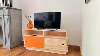 a tv on a wooden stand with a television on it at 201 Loft Lumineux en Hyper-Centre in Liège