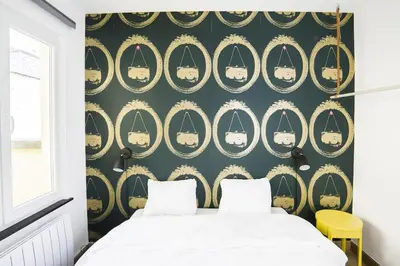 a bedroom with a black and gold wallpaper and a bed at 302 Le Spot Neuvice in Liège
