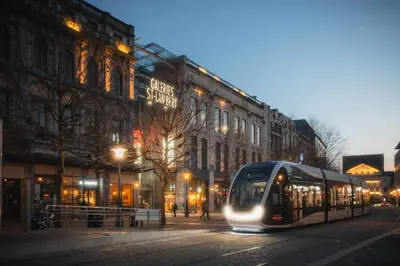 a bus driving down a city street at night at 302 Le Spot Neuvice in Liège
