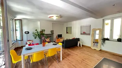 a living room with a table and yellow chairs at 301 Loft Chic Central in Liège