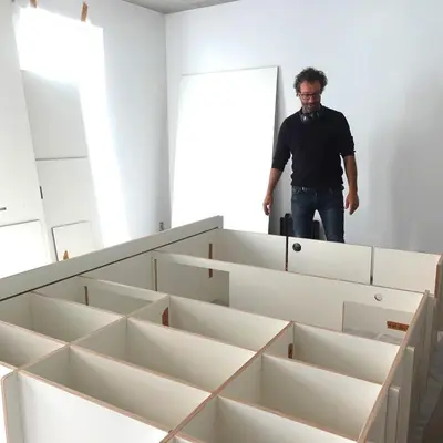a man standing in a room with boxes at 303 Loft design Cathéderale in Liège