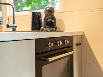 a kitchen with a sink and a stove at Boshuisje Rekem - Plum in Lanaken