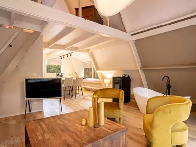 a living room with yellow chairs and a television at Boshuisje Rekem - Plum in Lanaken