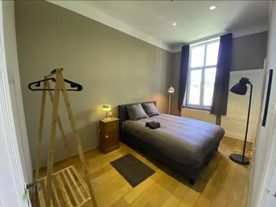 a bedroom with a bed and a ladder in it at Liège Centre-ville by WelcHome in Liège