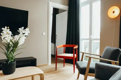 a living room with chairs and a table at Liège Centre-ville by WelcHome in Liège