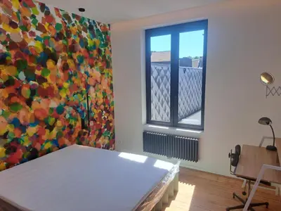 a room with a bed and a window at Chambre luxe in Liège