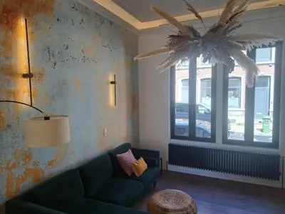 a living room with a couch and a window at Chambre luxe in Liège