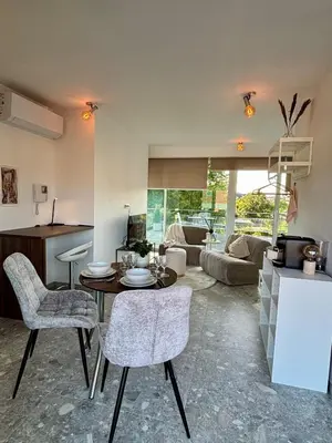 a kitchen and living room with a table and chairs at GG'S studio in Hasselt
