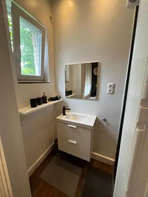 a bathroom with a sink and a mirror at home sweet home in Liège