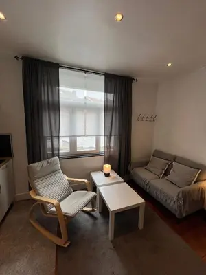a small living room with a couch and a table at home sweet home in Liège
