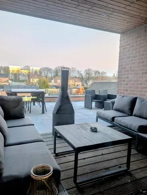 a living room with couches and a coffee table at Duplex appartement met 3 slaapkamers in Genk