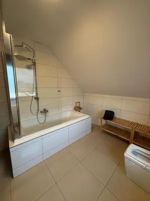 a bathroom with a shower and a tub and a toilet at Duplex appartement met 3 slaapkamers in Genk