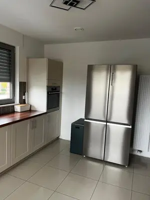 a kitchen with stainless steel refrigerators in a room at Duplex appartement met 3 slaapkamers in Genk