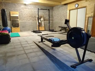 a room with a gym with several machines at Luxe loft in vierkantshoeve in Sint-Truiden