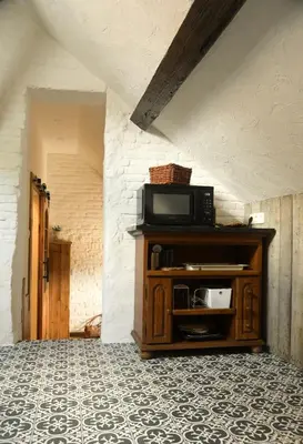 a microwave sitting on top of a cabinet in a room at Luxe loft in vierkantshoeve in Sint-Truiden
