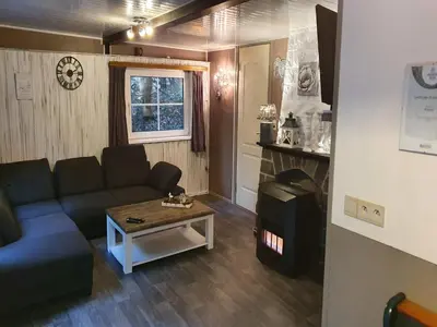 a living room with a couch and a coffee table at Forest Chalet in Lanklaar in Lanklaar