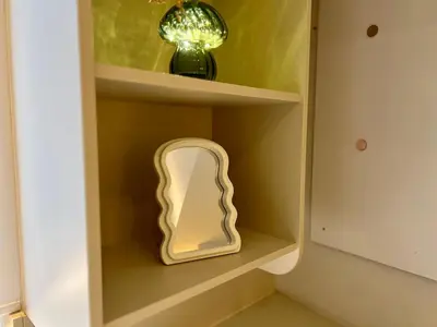 a shelf with a mirror and a vase on it at Business trip - Sauna, gym, rooftop in Liège