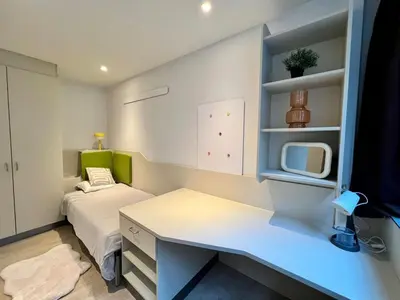 a small room with a bed and a desk at Business trip - Sauna, gym, rooftop in Liège