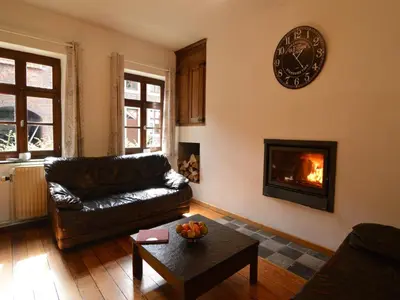 a living room with a couch and a fireplace at Farm Stay with Sauna, Teuven in Teuven