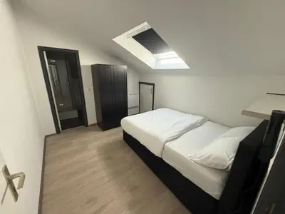 a bedroom with a white bed and a skylight at Melo in Plombières