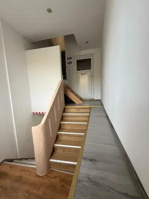 a staircase in a room with a white wall at Melo in Plombières