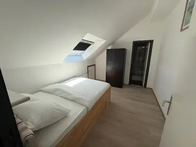 a bedroom with a bed and a skylight at Melo in Plombières