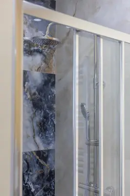 a shower with a glass door with a shower at Chambres de luxe SDB WC Privés in Liège