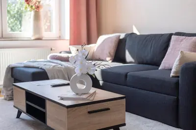 a living room with a blue couch and a coffee table at Appartement romantique de luxe à Liège Chambre, salon SDB privée 2e étage in Liège