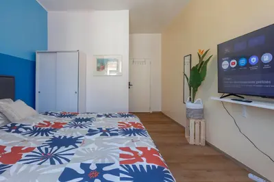a bedroom with a bed and a flat screen tv at Chambre de luxe RIO a Liège Sale de bain privée check in autonome cuisine partagée in Liège