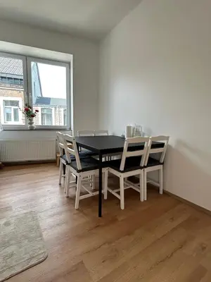 a dining room with a black table and chairs at Chambre de luxe RIO a Liège Sale de bain privée check in autonome cuisine partagée in Liège