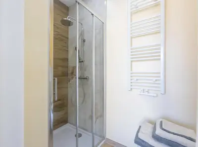 a shower with a glass door in a bathroom at Chambre de luxe Tokyo a Liège Sale de bain privée check in autonome cuisine partagée in Liège