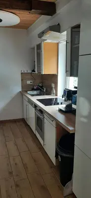 a kitchen with a sink and a stove top oven at Gîte 