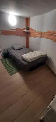 a small bedroom with a bed in a room at Gîte 