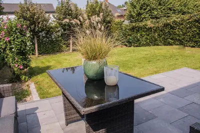 a table with a glass vase on top of it at Green& Light House16 in Kettenis