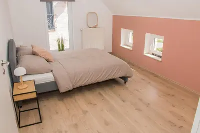 a bedroom with a bed and a wooden floor at Green& Light House16 in Kettenis