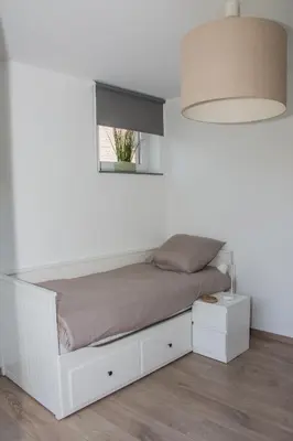 a bedroom with a white bed with a window at Green& Light House16 in Kettenis