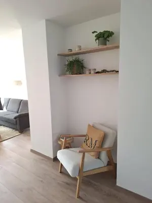 a living room with a chair and a couch at Green& Light House16 in Kettenis