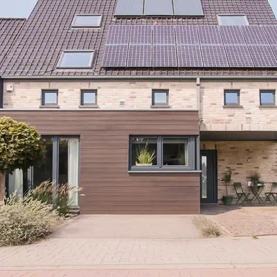 a house with a wooden facade with a roof at Green& Light House16 in Kettenis