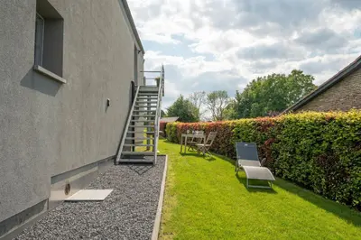 a garden with a staircase next to a building at L étage in Soumagne