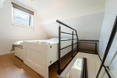 a bedroom with a bunk bed and a window at L étage in Soumagne